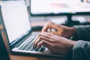 person writing review on computer