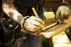 contractor with pencil on wood - Best Contractor Estimating & Invoicing Software - Hearth