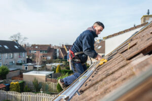 man on top of roof roofing - Best Contractor Estimating & Invoicing Software - Hearth