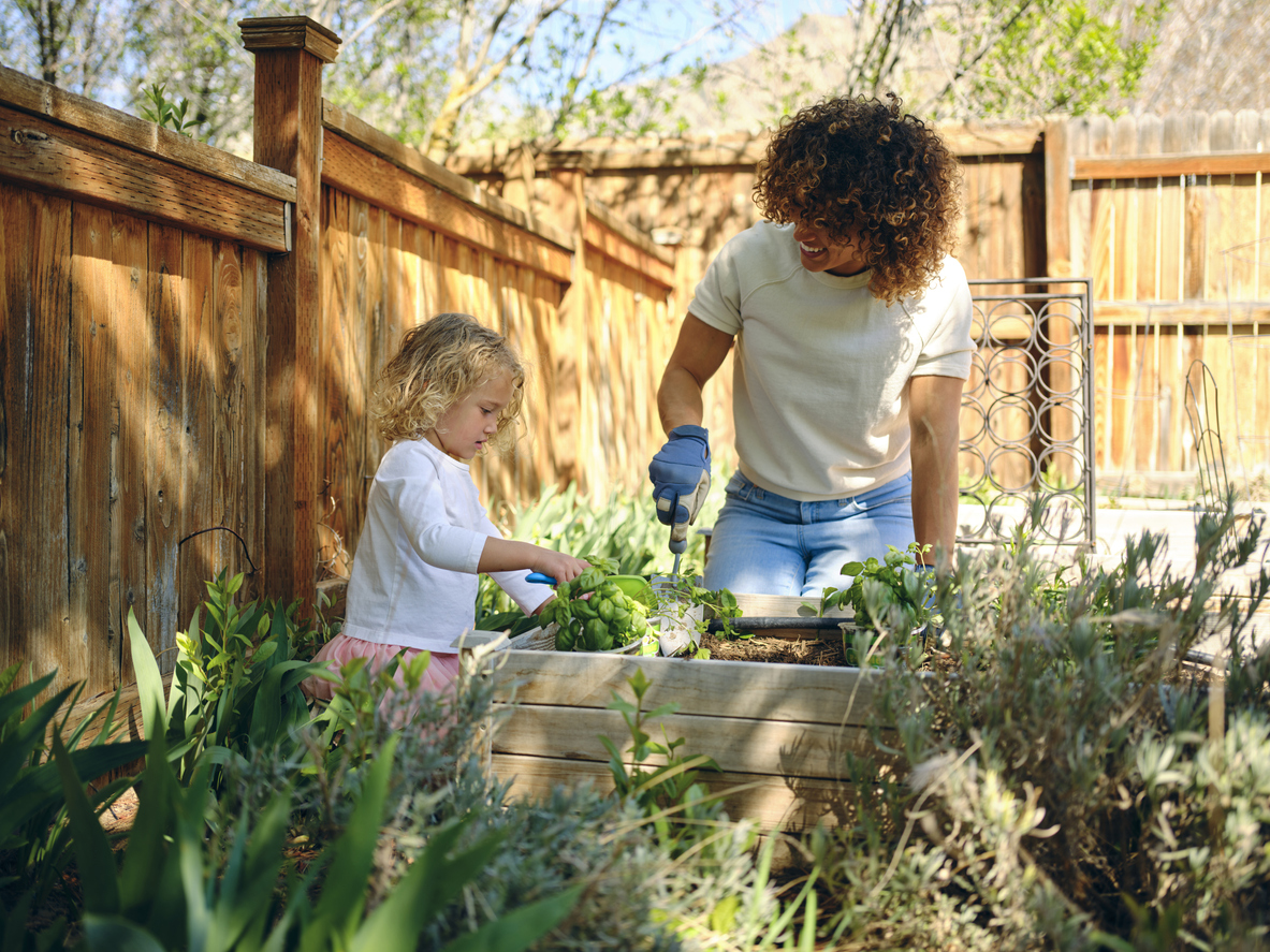 family gardening with fence in the background
